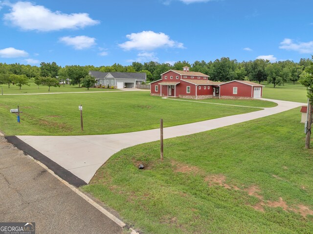 view of exterior entry featuring a lawn and a patio area