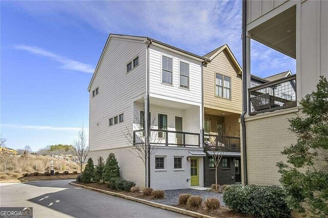 view of front of house featuring a balcony