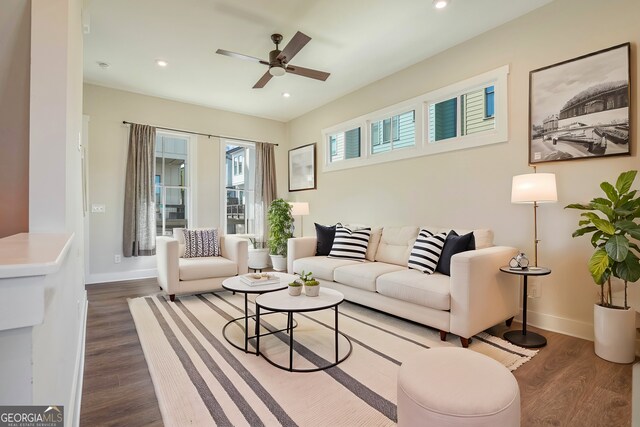 living room with dark wood-type flooring and ceiling fan