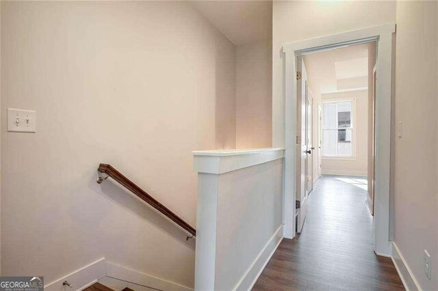 hallway with dark hardwood / wood-style floors