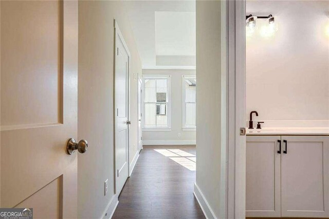 hallway with hardwood / wood-style flooring