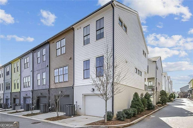 view of building exterior with a garage and cooling unit