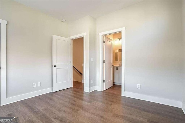 unfurnished bedroom with dark hardwood / wood-style floors