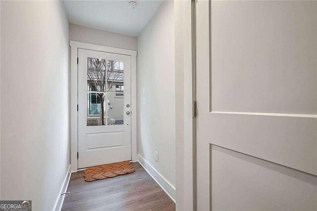 doorway to outside with light wood-type flooring