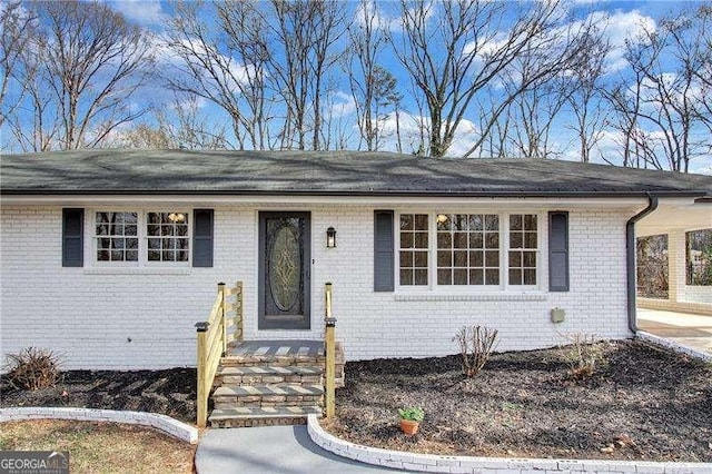 single story home with a carport and a front lawn