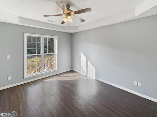 empty room featuring ceiling fan, hardwood / wood-style floors, and a textured ceiling