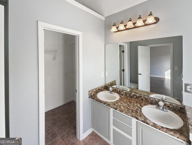 bathroom with tile patterned flooring, vanity, and toilet