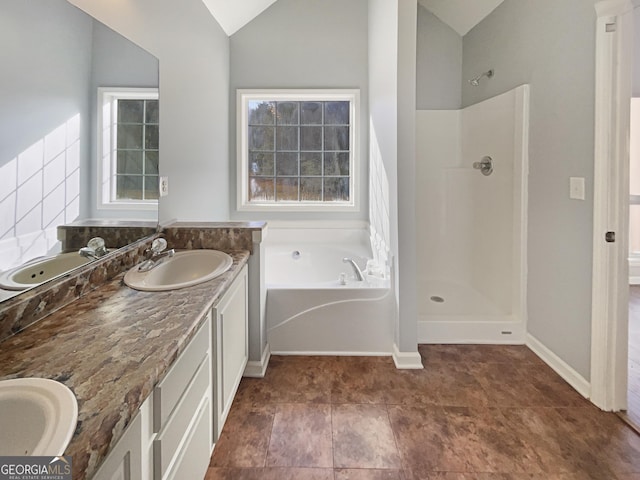 bathroom featuring lofted ceiling, vanity, and shower with separate bathtub