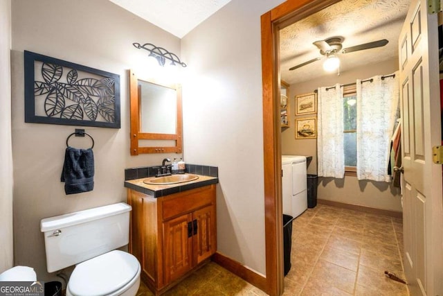 bathroom featuring vanity, separate washer and dryer, ceiling fan, and toilet