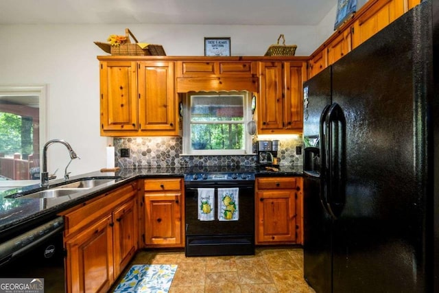 kitchen featuring tasteful backsplash, sink, black appliances, and dark stone countertops