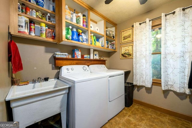 laundry room with ceiling fan, washer and clothes dryer, sink, and a textured ceiling