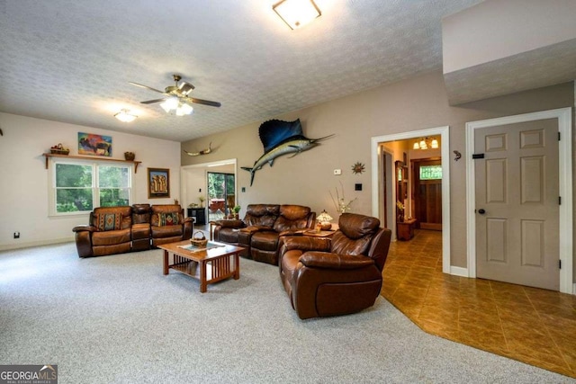 living room with ceiling fan, carpet, and a textured ceiling