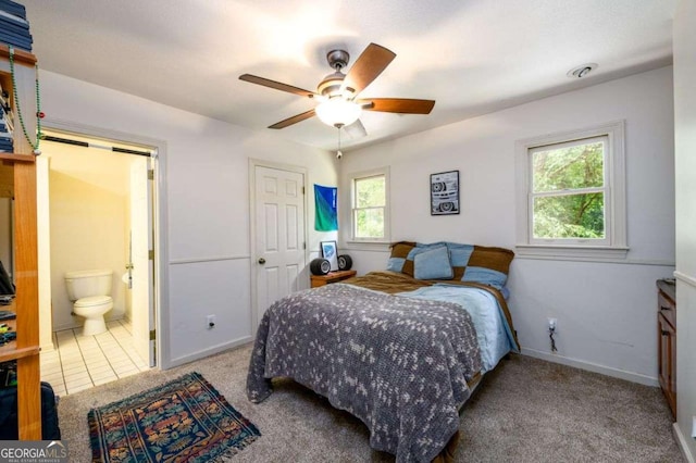 bedroom featuring carpet, connected bathroom, and ceiling fan