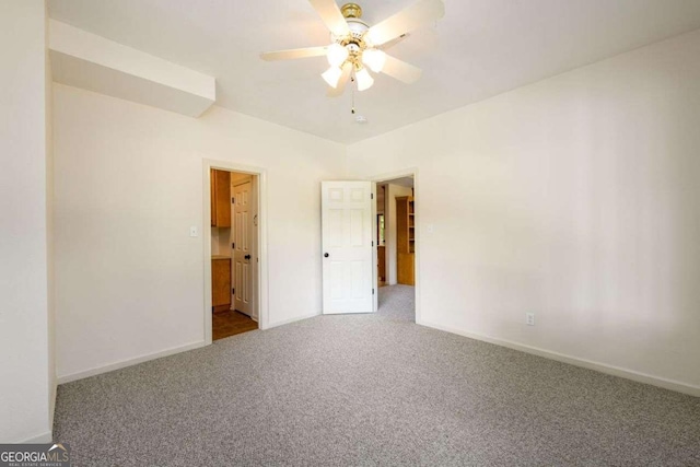 carpeted spare room with ceiling fan