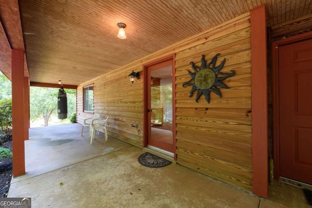 view of exterior entry with a porch