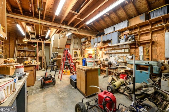 miscellaneous room with concrete floors and a workshop area