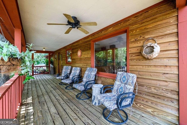 wooden deck with covered porch and ceiling fan