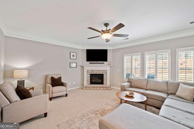 living room with crown molding, light colored carpet, a fireplace, and ceiling fan