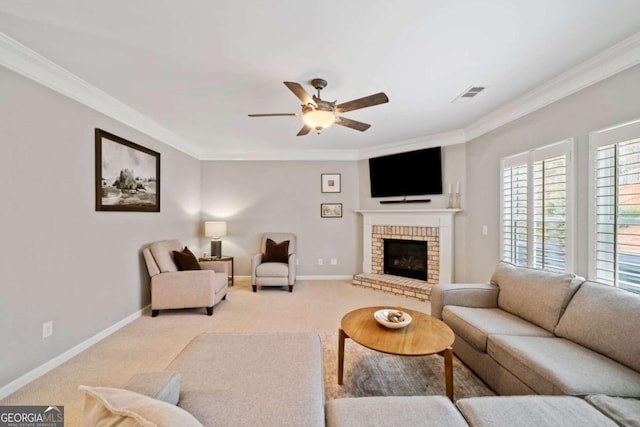 carpeted living room with a brick fireplace, ornamental molding, and ceiling fan