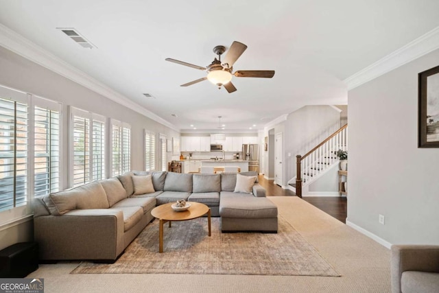 living room featuring ornamental molding and ceiling fan