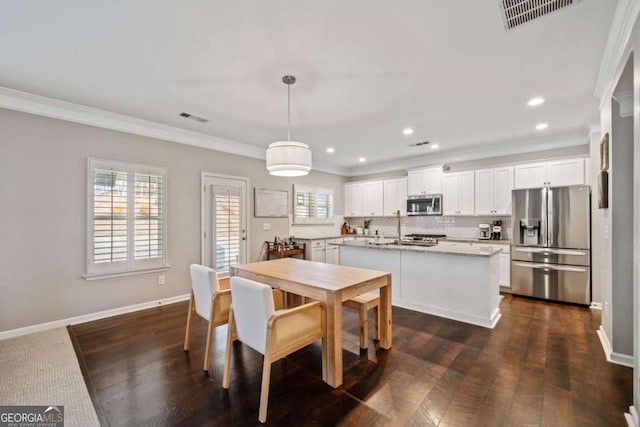 dining room featuring crown molding and dark hardwood / wood-style flooring