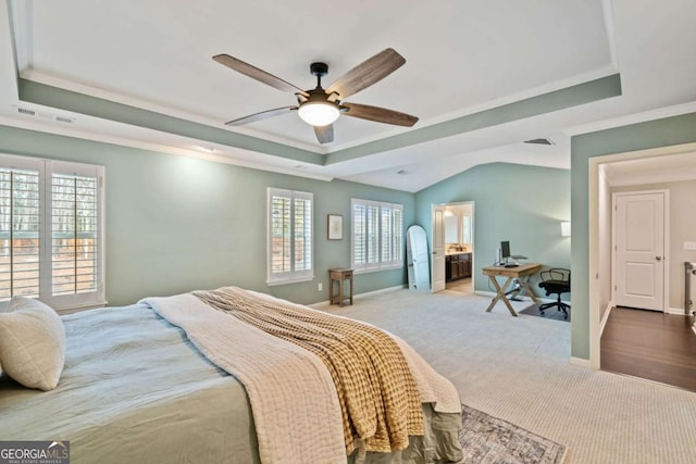 bedroom featuring a raised ceiling, ornamental molding, and carpet