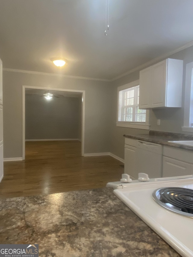 kitchen featuring dark wood-type flooring, ornamental molding, dishwasher, and white cabinets