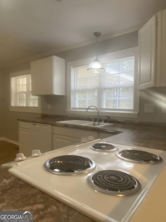 kitchen featuring sink, dishwasher, range, white cabinetry, and decorative light fixtures