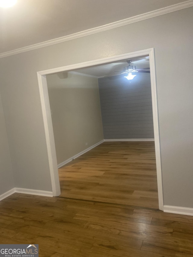 unfurnished room with dark wood-type flooring and crown molding