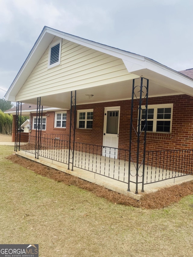 view of property exterior with a lawn