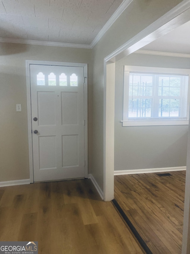 entryway with crown molding and dark hardwood / wood-style floors