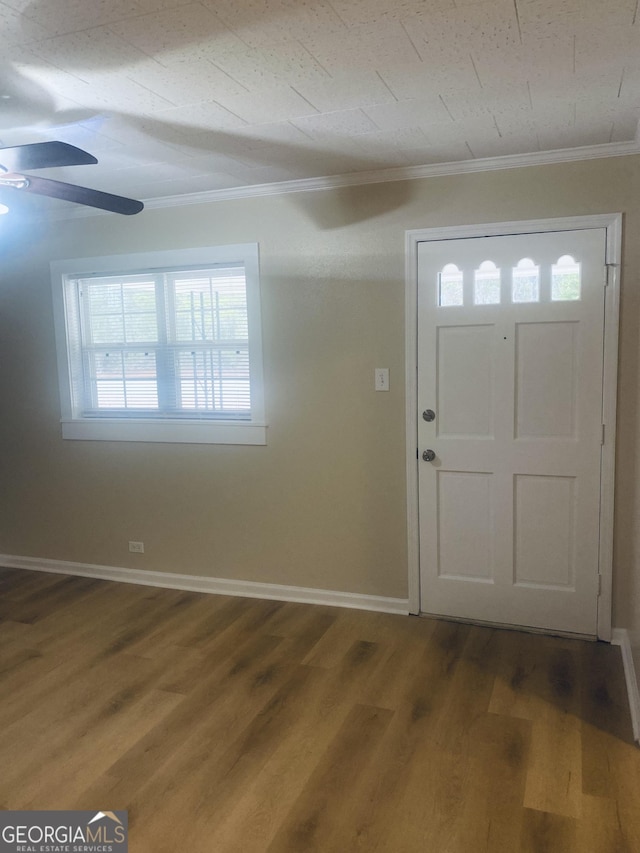 entrance foyer featuring ornamental molding, hardwood / wood-style floors, and ceiling fan