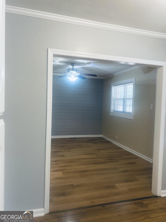 unfurnished room featuring dark hardwood / wood-style flooring, crown molding, and ceiling fan