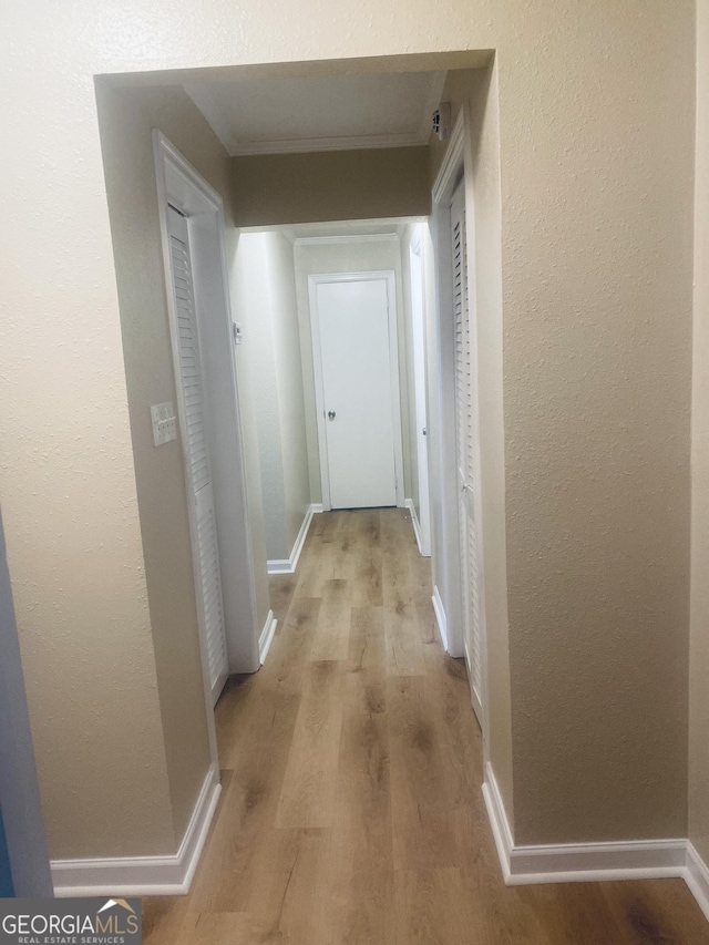 hallway with light hardwood / wood-style floors