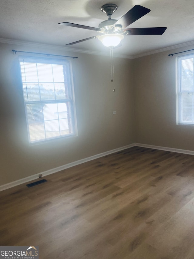 unfurnished room featuring crown molding and hardwood / wood-style floors