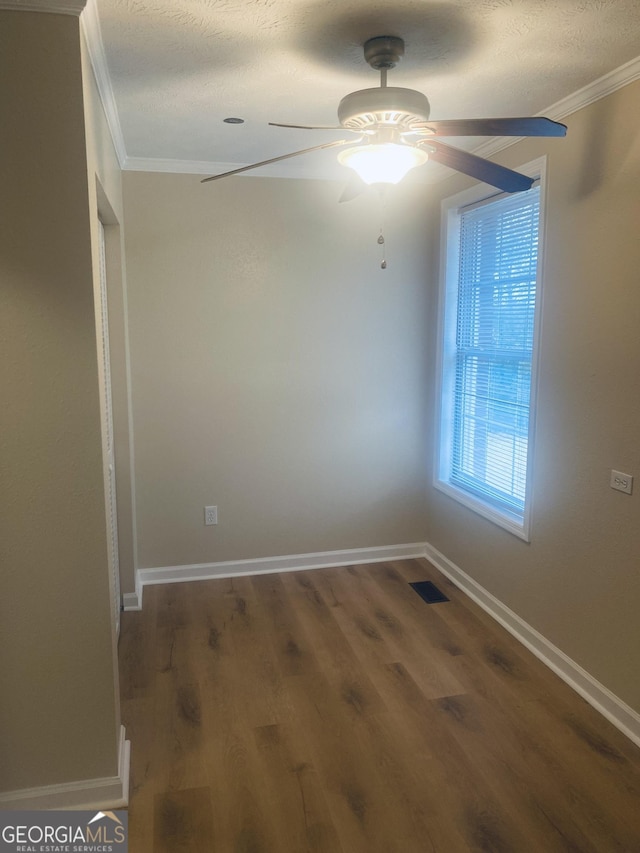 unfurnished room with ornamental molding, ceiling fan, a textured ceiling, and dark hardwood / wood-style flooring