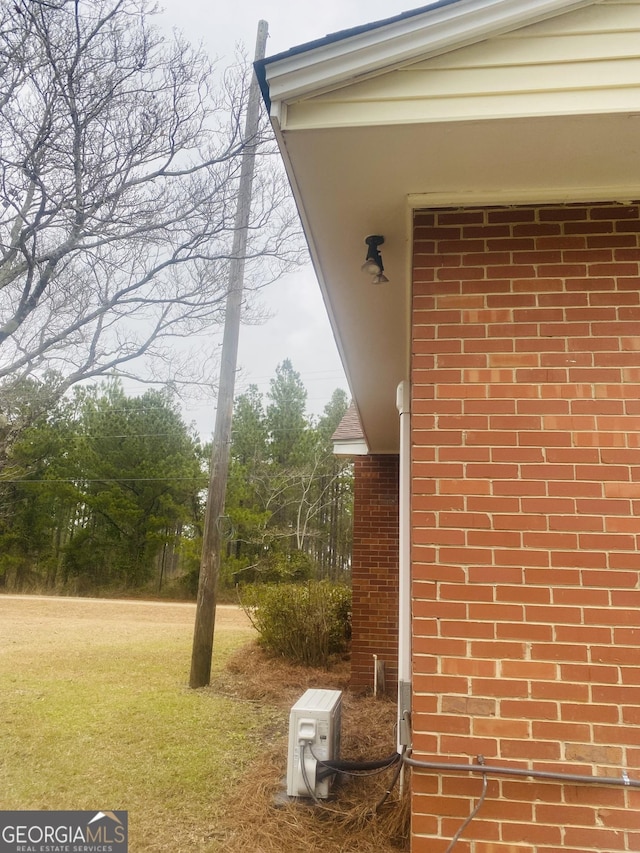 exterior space with a lawn and ac unit