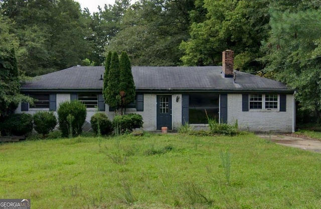 ranch-style home with a front lawn