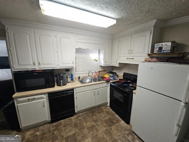 kitchen featuring sink, black appliances, and white cabinets