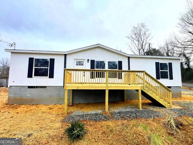 rear view of house with a wooden deck