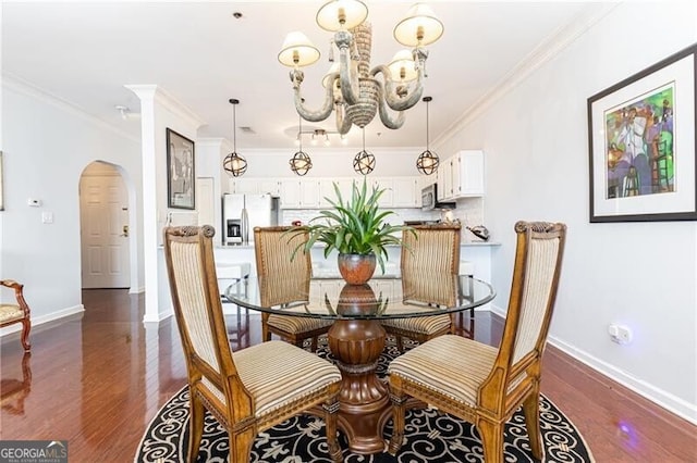 dining space with a notable chandelier, crown molding, and dark hardwood / wood-style floors