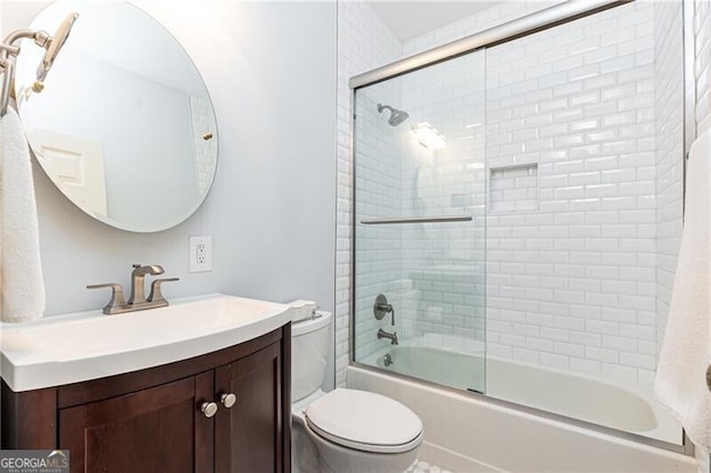 full bathroom with bath / shower combo with glass door, vanity, and toilet