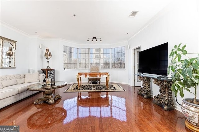 living room with crown molding and hardwood / wood-style floors