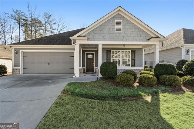 view of front of property with a garage, covered porch, and a front lawn