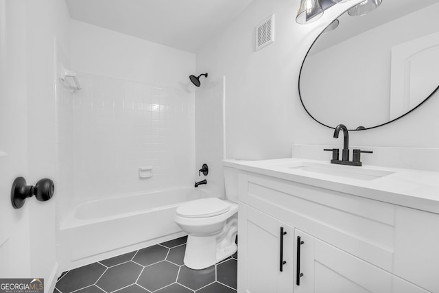 full bathroom with tiled shower / bath combo, vanity, tile patterned floors, and toilet