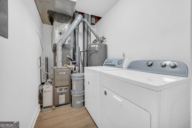 laundry area featuring light hardwood / wood-style floors, washing machine and dryer, and gas water heater