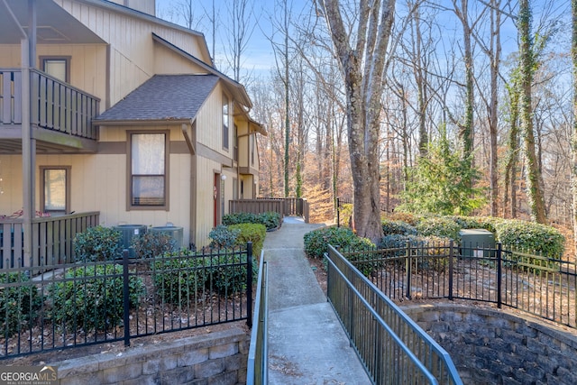 view of side of property featuring central AC and a balcony