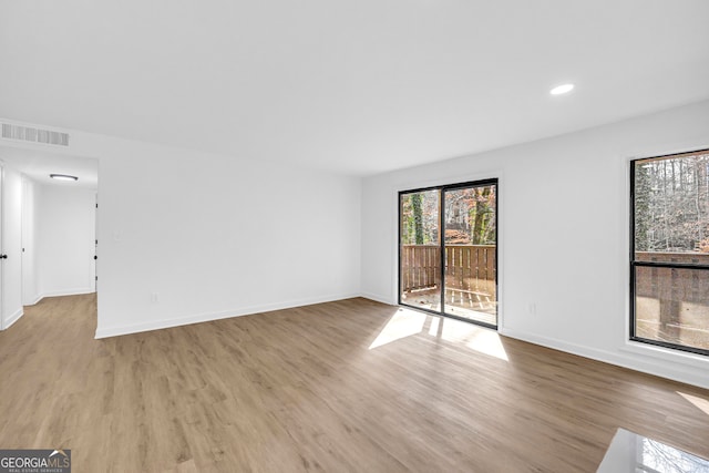 empty room with light hardwood / wood-style floors