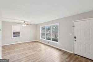 foyer with hardwood / wood-style floors and ceiling fan