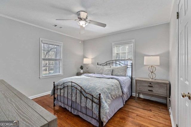 bedroom featuring ornamental molding, hardwood / wood-style floors, and multiple windows